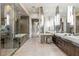Luxurious bathroom showcasing dual sinks, modern fixtures, a glass shower, and a standalone tub at 8 Meadowhawk Ln, Las Vegas, NV 89135