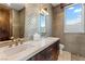 Spa bathroom with double sinks, modern fixtures, and mosaic tile accent wall at 8 Meadowhawk Ln, Las Vegas, NV 89135