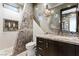 Stylish bathroom featuring a modern sink, triangular tile accent wall, and decorative lighting at 8 Meadowhawk Ln, Las Vegas, NV 89135