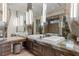 Modern bathroom with dual vanities, sleek mirrors, and elegant lighting fixtures creating a spa-like atmosphere at 8 Meadowhawk Ln, Las Vegas, NV 89135