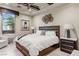 Comfortable bedroom with a ceiling fan, a large window and an accent wall behind the bed at 8 Meadowhawk Ln, Las Vegas, NV 89135