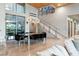Elegant dining room with modern chandelier, staircase, and adjacent glass-enclosed patio at 8 Meadowhawk Ln, Las Vegas, NV 89135