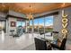 Bright exercise room features a modern chandelier, exercise equipment, and mountain views at 8 Meadowhawk Ln, Las Vegas, NV 89135
