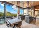 Open kitchen with island, bar seating, and an outdoor dining area at 8 Meadowhawk Ln, Las Vegas, NV 89135