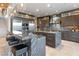 Contemporary kitchen with island, stainless steel appliances, and modern lighting at 8 Meadowhawk Ln, Las Vegas, NV 89135