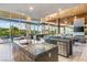 Gourmet kitchen with stainless steel appliances and bar area with outdoor view at 8 Meadowhawk Ln, Las Vegas, NV 89135
