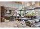 Open kitchen and bar area with sleek countertops and views of the living room at 8 Meadowhawk Ln, Las Vegas, NV 89135
