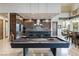 Open kitchen and bar area adjacent to a game area with pool table at 8 Meadowhawk Ln, Las Vegas, NV 89135