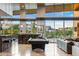 Bright living room with a billiards table, bar, and panoramic windows at 8 Meadowhawk Ln, Las Vegas, NV 89135