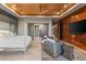 Spacious main bedroom with wood ceiling, a sitting area, sliding doors and accent wall behind the bed at 8 Meadowhawk Ln, Las Vegas, NV 89135
