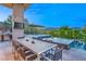 Inviting outdoor dining area featuring a built-in kitchen, bar, and serene water feature at 8 Meadowhawk Ln, Las Vegas, NV 89135