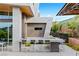 Outdoor kitchen with bar seating, grill, and modern design at 8 Meadowhawk Ln, Las Vegas, NV 89135