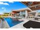 Resort style pool with a swim up bar and outdoor kitchen under an awning at 8 Meadowhawk Ln, Las Vegas, NV 89135