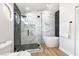 Bright bathroom showcasing a glass shower with black and white tiles, and a freestanding tub at 8113 Bay Springs Dr, Las Vegas, NV 89128