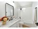 Bright bathroom featuring a tub with white tiling, a modern vanity, and neutral decor at 8113 Bay Springs Dr, Las Vegas, NV 89128