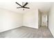 Large bedroom featuring neutral walls, a ceiling fan, and an open doorway at 8113 Bay Springs Dr, Las Vegas, NV 89128
