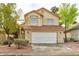 Inviting two-story home with a manicured front yard, lush trees, and a convenient two-car garage at 8113 Bay Springs Dr, Las Vegas, NV 89128