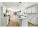 Bright open kitchen featuring stainless appliances, white cabinets, island, and stone countertops at 8113 Bay Springs Dr, Las Vegas, NV 89128