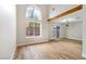 Bright living room with wood floors, large arched windows, and modern light fixture at 8113 Bay Springs Dr, Las Vegas, NV 89128