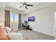 Neutral bedroom features wood-look floors, ceiling fan, and large window with views plus a TV at 8255 Las Vegas Blvd # 1821, Las Vegas, NV 89123