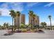 Two high-rise residential buildings surrounded by palm trees, circle drive, and well-kept landscaping at 8255 Las Vegas Blvd # 1821, Las Vegas, NV 89123