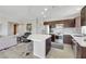 Contemporary kitchen featuring a center island, stainless steel appliances, and dark wood cabinets at 8255 Las Vegas Blvd # 1821, Las Vegas, NV 89123