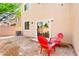 Private backyard area with a sliding glass door to the home and two red chairs at 8316 Mokena Ave, Las Vegas, NV 89178