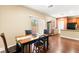 Charming dining area with wood table and chairs, next to a patio door with lots of natural light at 8316 Mokena Ave, Las Vegas, NV 89178