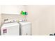 Functional laundry room with a washer, a dryer, and shelving for storage at 8316 Mokena Ave, Las Vegas, NV 89178