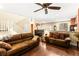 Open-concept living room with wood floors, staircase, and comfortable seating arrangement at 8316 Mokena Ave, Las Vegas, NV 89178