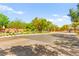 Quiet neighborhood street entrance, trees, shrubbery, with controlled-access gates at 8316 Mokena Ave, Las Vegas, NV 89178