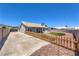 Large backyard featuring a long drive and artificial turf at 842 Envoy Cir, Henderson, NV 89002
