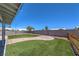 The fenced backyard features artificial turf and a brick walkway leading to the covered patio at 842 Envoy Cir, Henderson, NV 89002