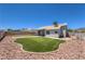 Backyard featuring artificial turf, rock landscaping, and a covered patio connected to the home at 842 Envoy Cir, Henderson, NV 89002