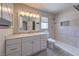 Updated bathroom with white vanity, marble countertop, and tiled walk-in shower at 842 Envoy Cir, Henderson, NV 89002