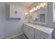 Beautiful bathroom featuring marble countertop, modern lighting, and white shaker cabinets at 842 Envoy Cir, Henderson, NV 89002