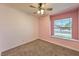 Charming bedroom featuring shiplap accent wall, window bench seat, and soft carpet at 842 Envoy Cir, Henderson, NV 89002