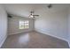 Spacious bedroom featuring wood-look flooring, ceiling fan, and natural light from the window at 842 Envoy Cir, Henderson, NV 89002
