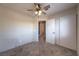 Bedroom with a ceiling fan, closet, carpet, and doorway to another room at 842 Envoy Cir, Henderson, NV 89002