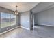 Open dining area with modern light fixture, large window with blinds, and wood-look flooring at 842 Envoy Cir, Henderson, NV 89002