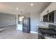 Bright kitchen with stainless steel appliances, white cabinets, and wood-look floors at 842 Envoy Cir, Henderson, NV 89002
