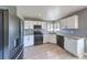 Well-lit kitchen with stainless steel appliances, granite countertops, and white cabinets at 842 Envoy Cir, Henderson, NV 89002
