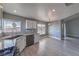 Updated kitchen featuring granite countertops, stainless appliances, and wood-look flooring at 842 Envoy Cir, Henderson, NV 89002