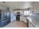 Well-lit kitchen featuring stainless steel appliances, granite countertops, and modern cabinetry at 842 Envoy Cir, Henderson, NV 89002