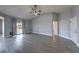 Spacious living room boasts wood-look floors, neutral paint, ceiling fan, and natural light at 842 Envoy Cir, Henderson, NV 89002