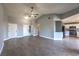 Open-concept living room with wood-look floors, a ceiling fan, and access to the kitchen at 842 Envoy Cir, Henderson, NV 89002