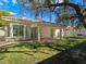 Lush backyard showcasing a covered patio, manicured lawn, and mature landscaping at 8981 Rivers Edge Dr, Las Vegas, NV 89117