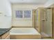 Bathroom featuring a tiled shower stall and a soaking tub under a window at 8981 Rivers Edge Dr, Las Vegas, NV 89117