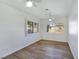 A bedroom with laminate flooring, plantation shutters on windows, and a dual ceiling fan at 8981 Rivers Edge Dr, Las Vegas, NV 89117