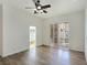 Bright bedroom with hardwood floors, ceiling fan, and sliding glass doors to the backyard at 8981 Rivers Edge Dr, Las Vegas, NV 89117